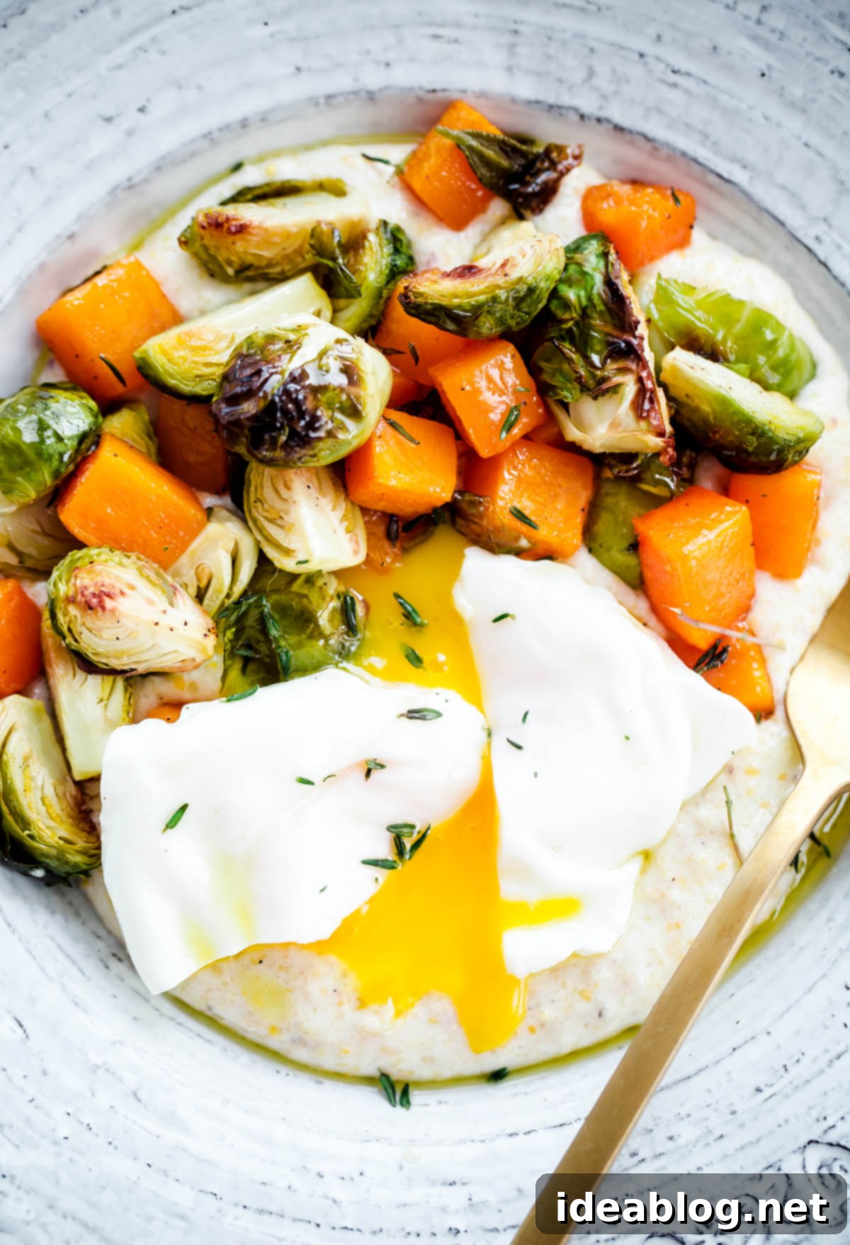 Creamy Goat Cheese Grits with Roasted Brussels Sprouts, Squash, and Poached Eggs 1 featured 25980