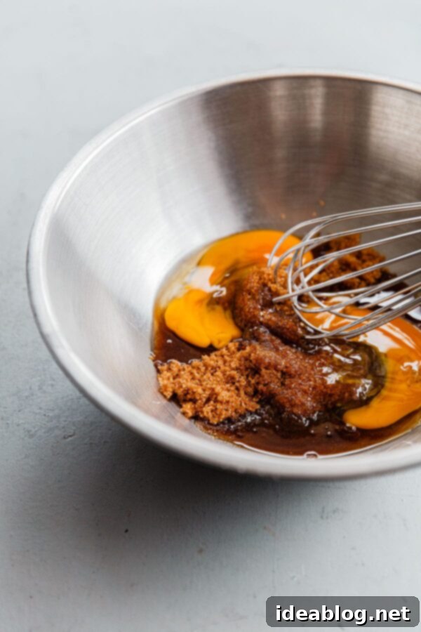 Apple Cinnamon Oat Loaf 8 Whisked Eggs and Brown Sugar in Bowl