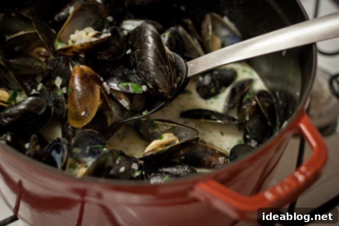 Quintessential Moules Frites 5 Classic Moules Frites served in a bowl with rich broth and fresh parsley