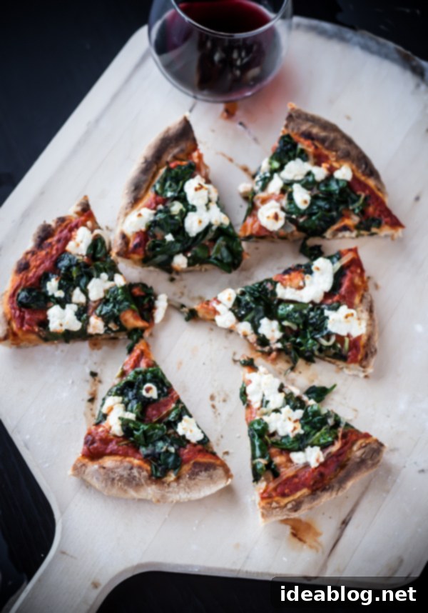 Fiery Feta Skillet Pizza 4 A whole Cast-Iron Skillet Pizza, vibrant with harissa, spinach, and feta, resting on a rustic wooden surface, inviting you to slice and serve.