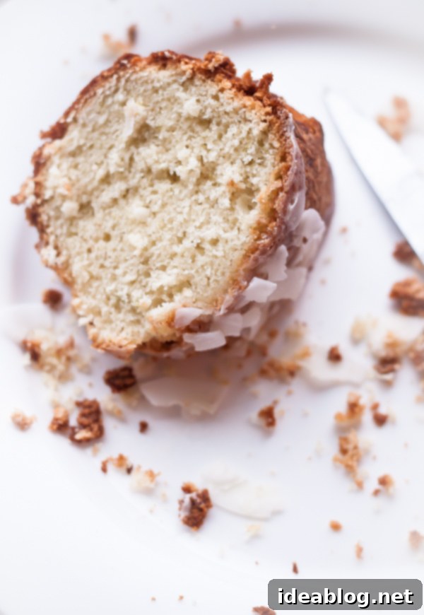 Zesty Coconut Cardamom Lime Bliss 3 Slice of Coconut Cardamom Lime Tea Cake on a plate