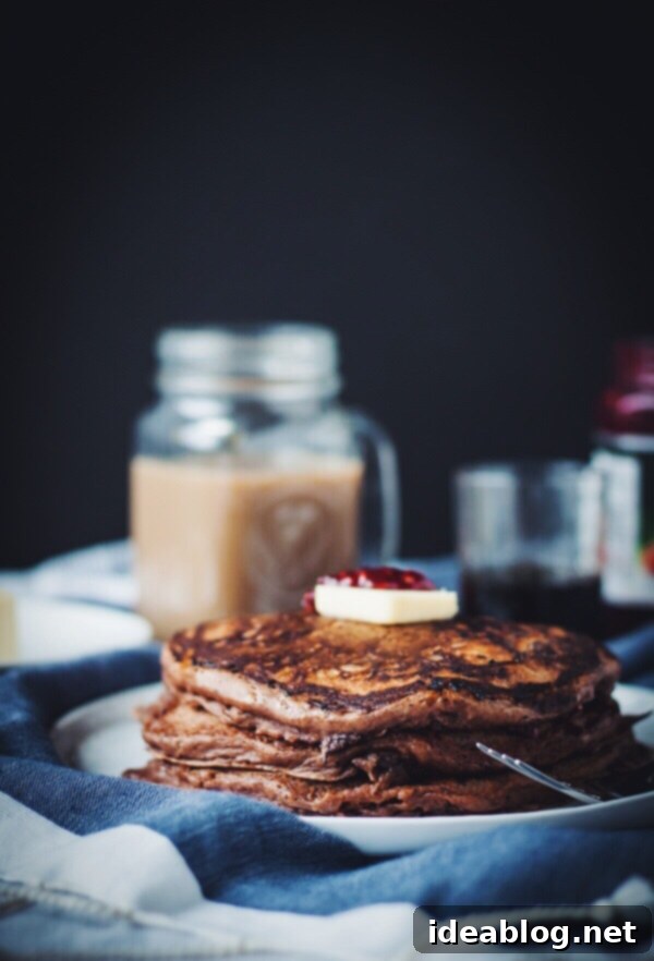 Luscious Chocolate Raspberry Swirl Pancakes 2 Deliciously fluffy chocolate raspberry swirl pancakes stacked high, drizzled with syrup