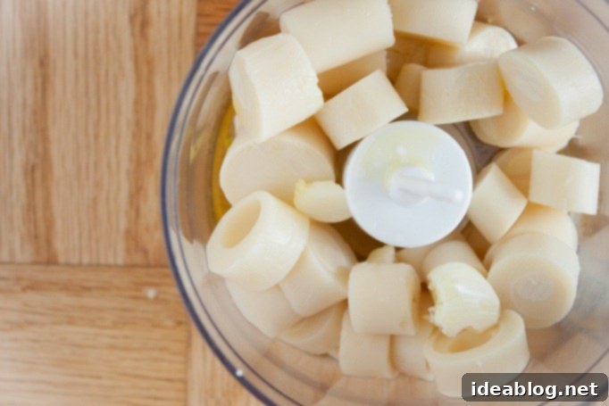 Velvet Palm Dip 4 Hearts of palm and other ingredients blending into a dip in a food processor