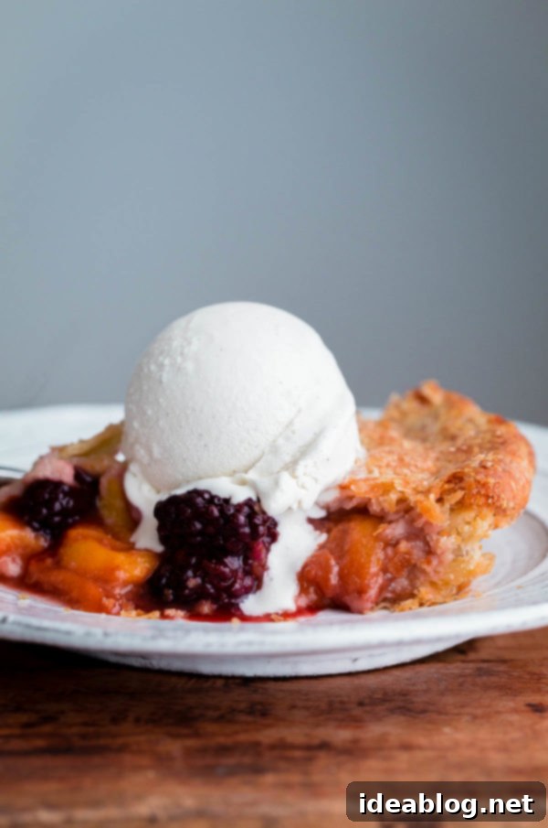 Sun-Kissed Blackberry Peach Delight 6 A close-up of a slice of Blackberry Peach Pie, revealing the vibrant fruit filling and the perfectly baked, flaky crust