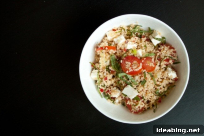 Sunshine Couscous Salad 4 A bowl filled with freshly cooked and fluffed couscous, awaiting the addition of fresh vegetables and dressing.