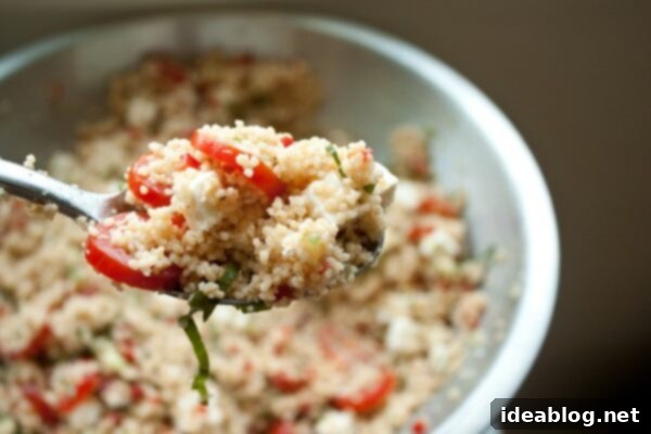 Sunshine Couscous Salad 5 A vibrant and colorful Summer Couscous Salad, perfectly tossed with fresh herbs, vegetables, and feta cheese, ready to be served.