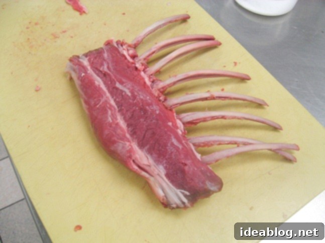 A Two-Day Culinary Journey: Pate, Merguez, Rack of Lamb, and Le Fraisier 4 Raw rack of lamb, meticulously trimmed and frenched, ready for cooking.