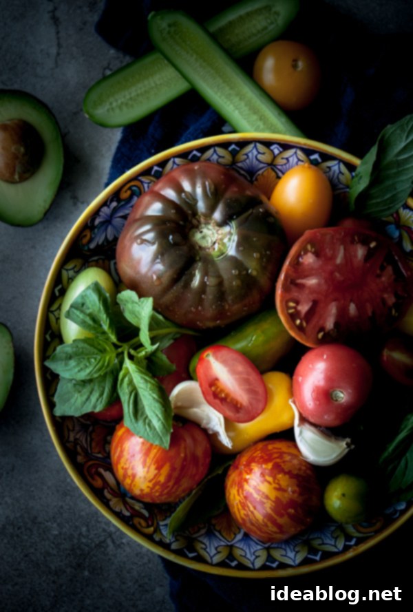 Velvety Heirloom Tomato and Avocado Gazpacho 3 Close-up of vibrant heirloom tomatoes and fresh avocado slices, key ingredients for gazpacho
