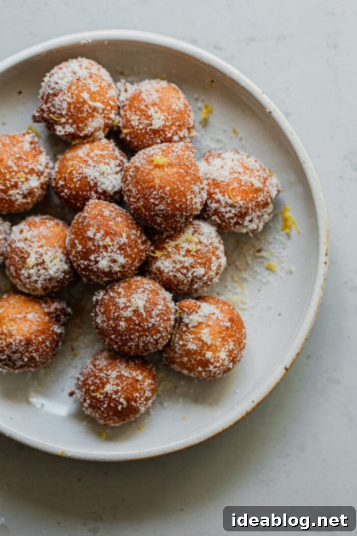 Lemon Cardamom Ricotta Donuts 5 Pile of golden brown, fluffy Ricotta Donut Holes ready to be enjoyed, highlighting their appealing texture.