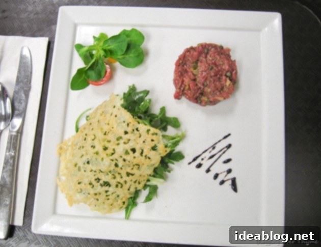 Day 55: Steak Tartare, Paella, & Souffle 2 Classic Steak Tartare served with arugula salad and parmesan tuile