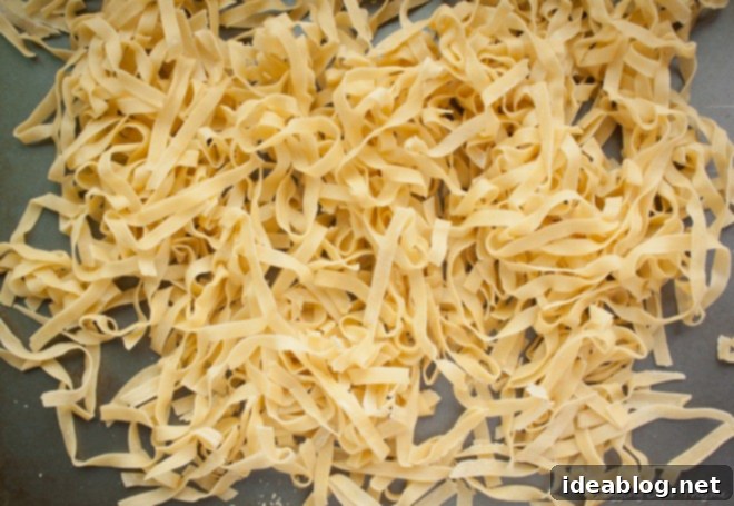 Effortless Fresh Pasta 2 Freshly kneaded homemade pasta dough on a wooden surface, ready for preparation