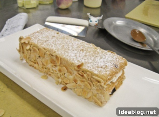 A Trio of French Delights: Chicken Roulade, Pommes Duchesse, and Marjolaine 2 Exquisite Marjolaine Cake with powdered sugar and toasted almonds