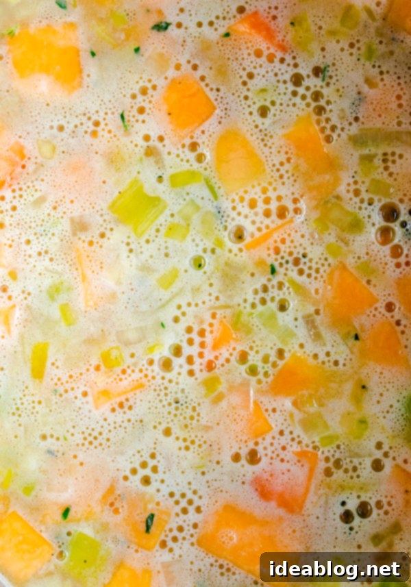 Velvety Butternut Leek Soup with Prosciutto Crisps and Crème Fraîche 5 Simmering Butternut Squash and Leek Soup in a Pot