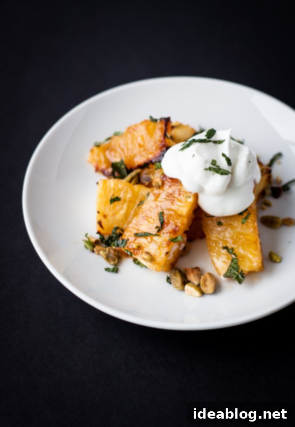 Healthy Roasted Pineapple Dessert or Breakfast Idea Delicious Roasted Pineapple slices drizzled with honey and garnished with pistachios and mint