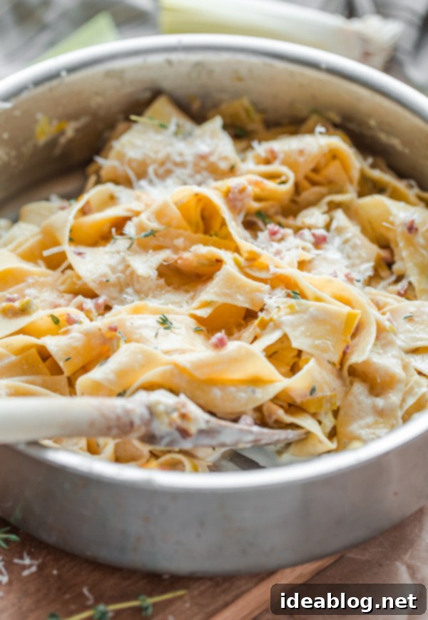 Finishing Creamy Leek and Pancetta Pappardelle Pasta in the pan, ready to serve Creamy Leek and Pancetta Pappardelle Pasta being tossed in a skillet