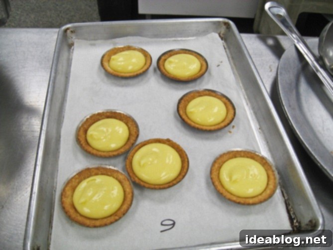 Day 19 Lemon Tartelettes Gnocchi and Grenobloise 7 Swiss Meringue being piped onto Key Lime Tartlets in elegant swirls