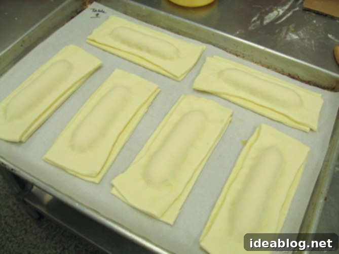 Day 16: French Bistro Delights 10 Rising puff pastry cheese sticks, golden and flaky, expanding beautifully in the oven during the baking process.