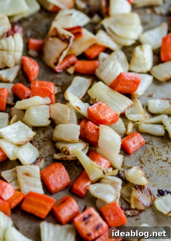 Roasted Vegetable Orzo Salad. A healthy, veggie-packed pasta with pecorino cheese and crunchy almonds!  Close-up of roasted carrots and fennel for an orzo salad recipe