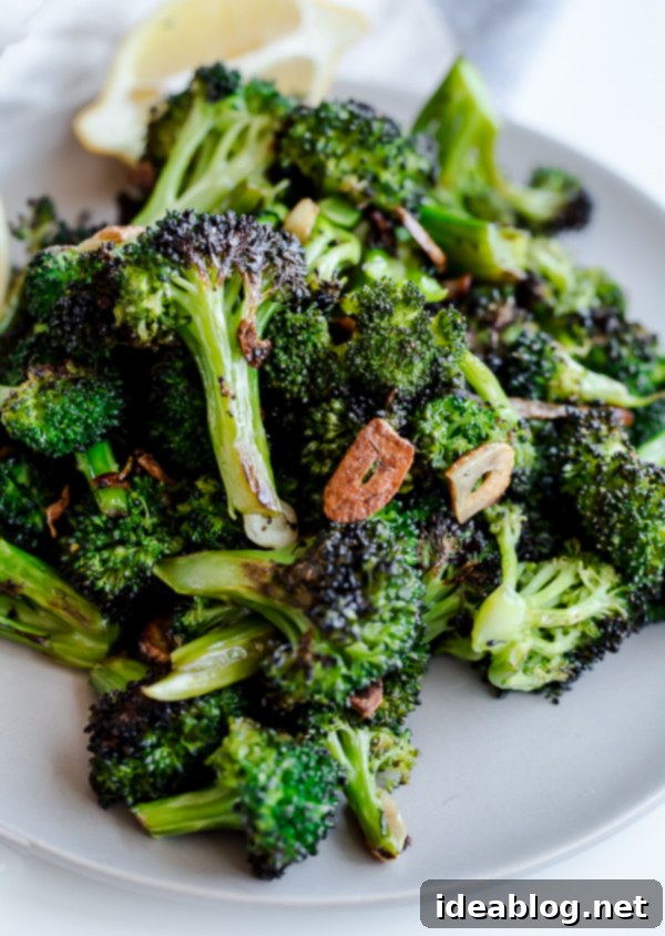 Roasted Vegetable Orzo Salad. A healthy, veggie-packed pasta with pecorino cheese and crunchy almonds!  Close-up of perfectly roasted broccoli florets with crispy garlic chips