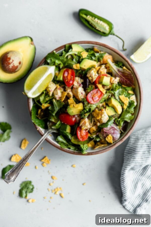 Guacamole Greens Salad with Cilantro Lime Jalapeño Vinaigrette--an easy, incredibly filling healthy main course salad tossed with a homemade cilantro lime vinaigrette! #salad #guacamole #abeautifulplate #chicken #recipe #avocado Guacamole Greens Salad - Sweetgreen Copycat Recipe