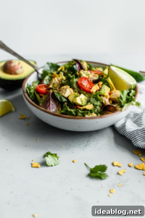Guacamole Greens Salad with Cilantro Lime Jalapeño Vinaigrette--an easy, incredibly filling healthy main course salad tossed with a homemade cilantro lime vinaigrette! #salad #guacamole #abeautifulplate #chicken #recipe #avocado Guacamole Greens Salad with Chicken and Avocado
