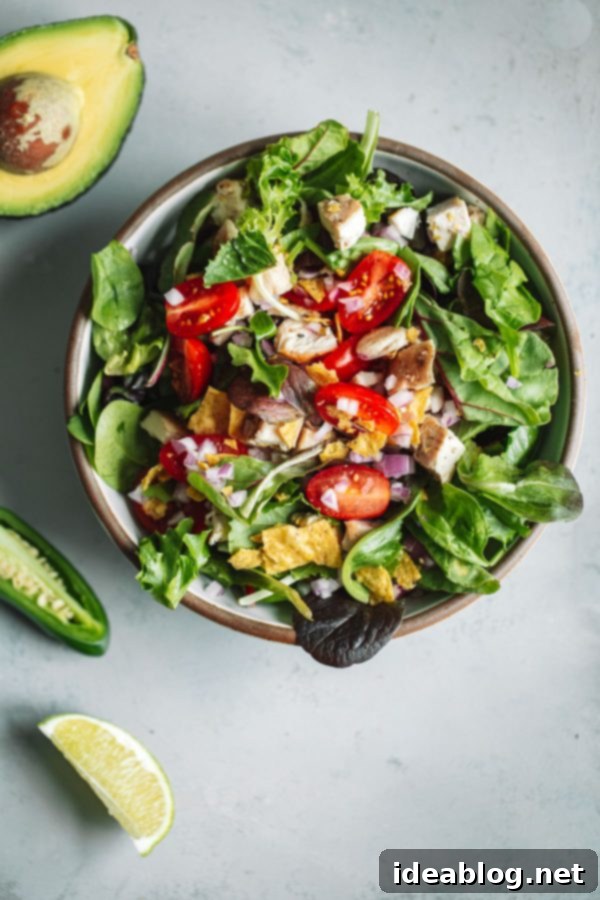 Guacamole Greens Salad with Cilantro Lime Jalapeño Vinaigrette--an easy, incredibly filling healthy main course salad tossed with a homemade cilantro lime vinaigrette! #salad #guacamole #abeautifulplate #chicken #recipe #avocado Guacamole Greens Salad Close Up