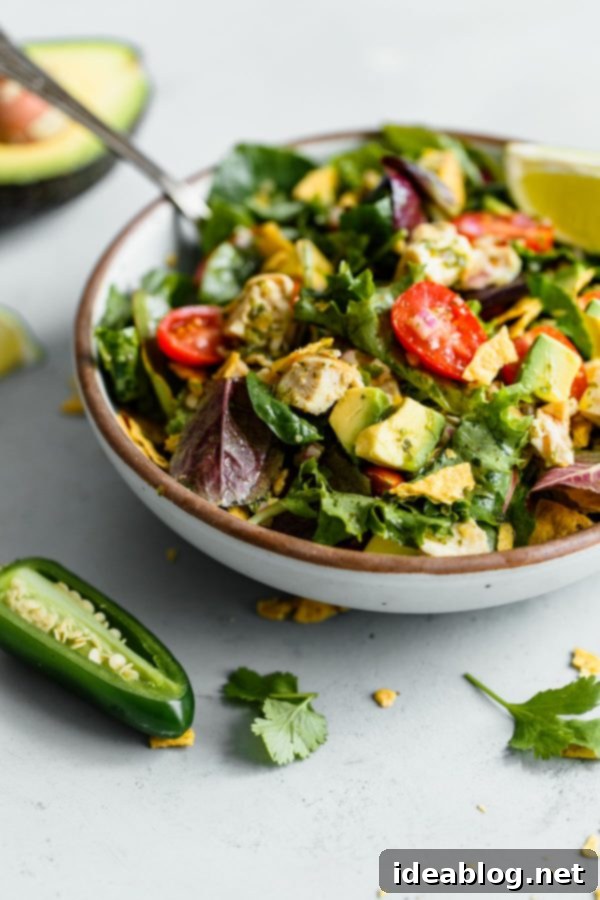 Guacamole Greens Salad with Cilantro Lime Jalapeño Vinaigrette--an easy, incredibly filling healthy main course salad tossed with a homemade cilantro lime vinaigrette! #salad #guacamole #abeautifulplate #chicken #recipe #avocado Guacamole Greens Salad with Cilantro Lime Dressing