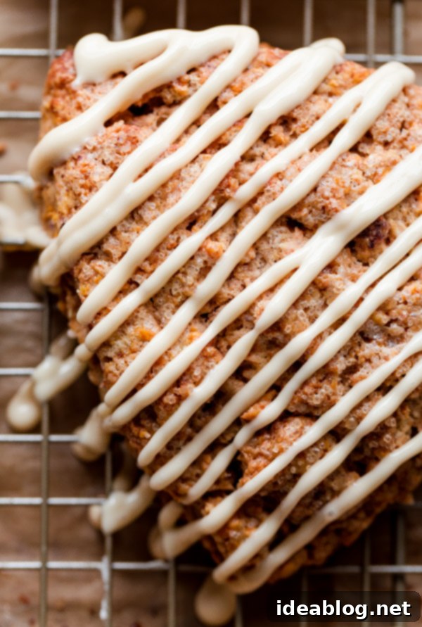 Spiced Carrot Cake Scones with Maple Cream Cheese Glaze 2 Fluffy Carrot Cake Scones with Maple Cream Cheese Glaze served on a plate for a spring brunch