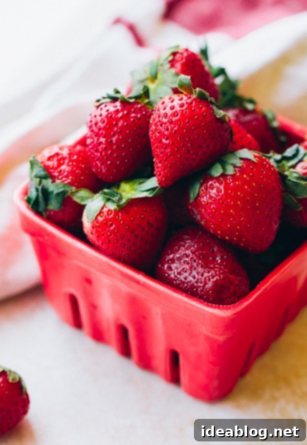 Basil-Kissed Strawberry Buttermilk Panna Cotta 3 Close-up of fresh, ripe strawberries, highlighting their vibrant red color and natural texture.