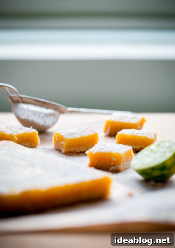 Bright Citrus Coconut Shortbread 4 Close-up of a perfectly cut Four Citrus Coconut Shortbread Bar, showcasing the thick curd and shortbread layers