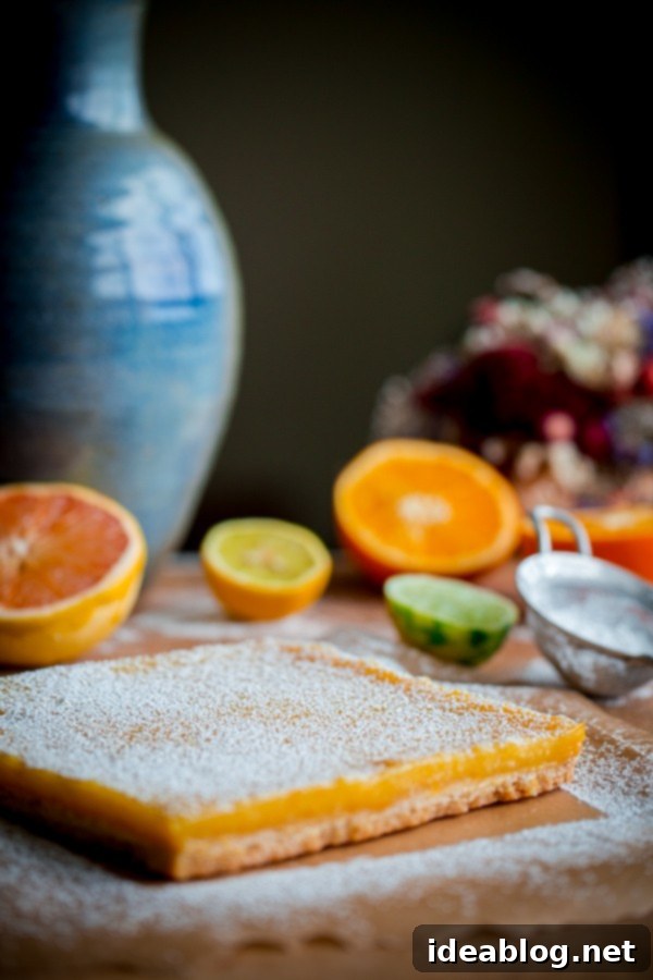 Bright Citrus Coconut Shortbread 6 Four Citrus Coconut Shortbread Bars, perfectly golden brown and dusted with powdered sugar, ready to be served