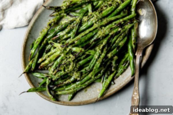 Fire-Kissed Green Beans with Zesty Cilantro Dressing 14 Charred Green beans on a serving platter with vinaigrette.
