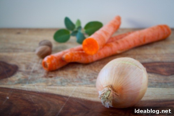 Creamy Golden Harvest 2 Carrots and Onion on a Cutting Board