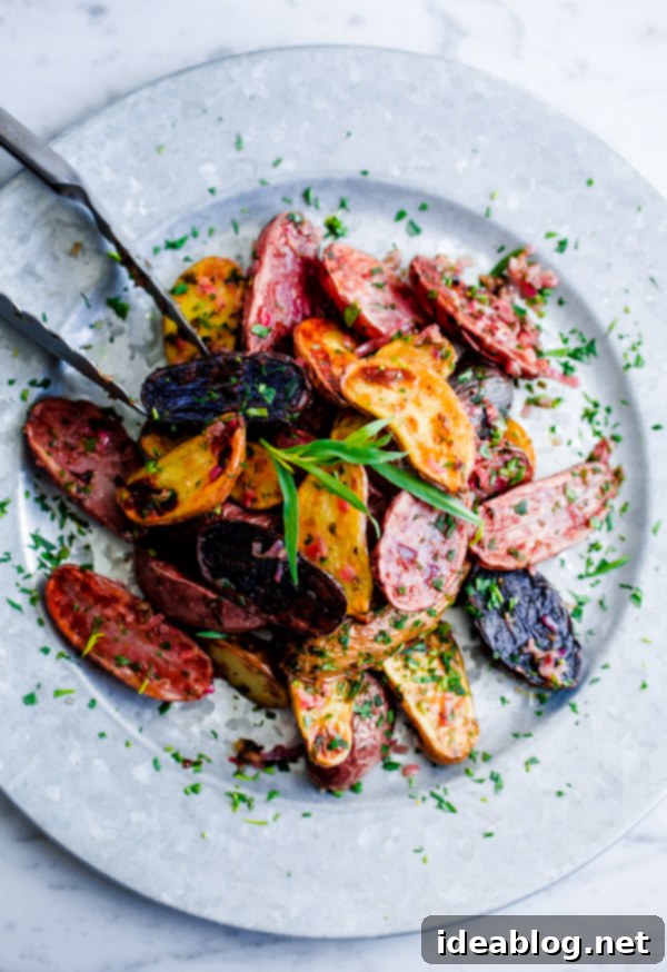 Close-up of golden-brown roasted fingerling potatoes, perfectly crispy and tender Crispy Roasted Fingerling Potatoes tossed with fresh herbs