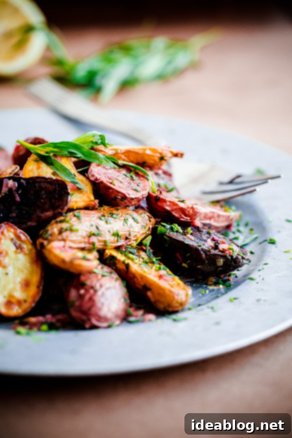 A bowl of vibrant roasted fingerling potatoes generously coated with Tarragon-Shallot Butter Roasted Fingerling Potatoes with Tarragon-Shallot Butter ready to serve in a bowl