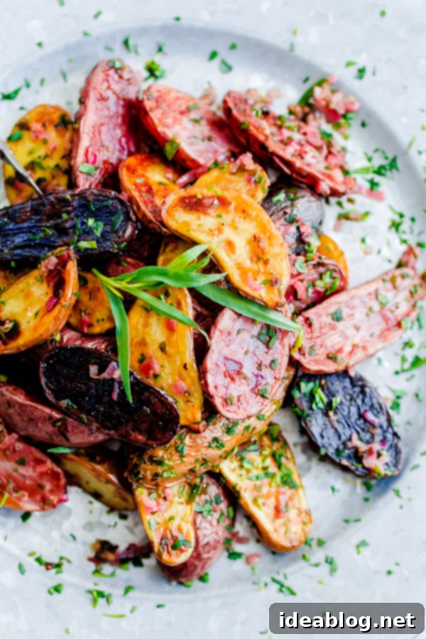 Deliciously roasted fingerling potatoes glistening with Tarragon-Shallot Butter, ready to eat Close-up of Roasted Fingerling Potatoes with Tarragon-Shallot Butter, perfectly coated