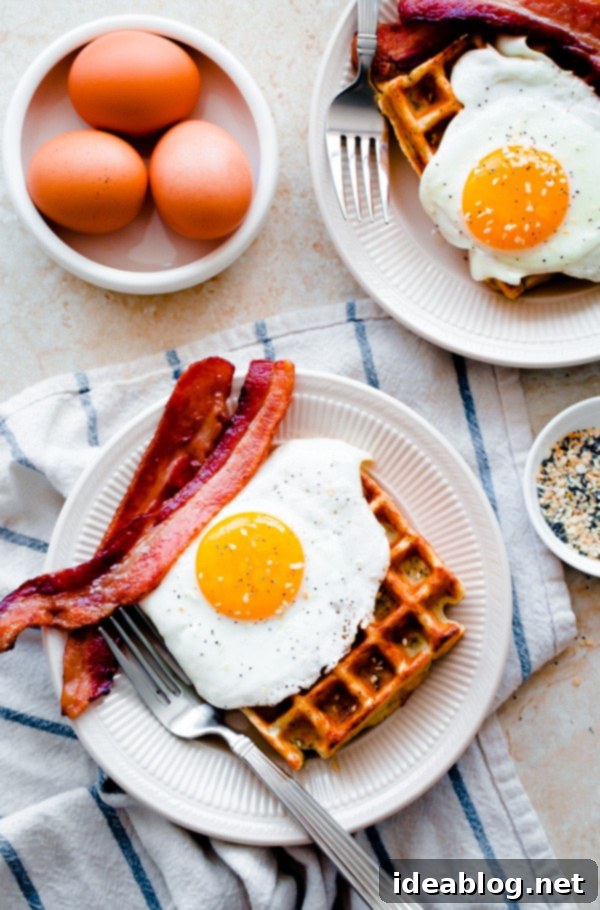 Everything-Spiced Morning Waffles 2 Everything Bagel Breakfast Waffles. Topped with sunny-side eggs and crispy bacon!