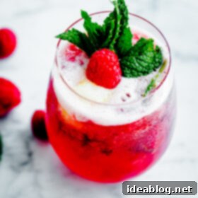 Effervescent Raspberry Mint Float 6 Sorbet Prosecco Floats with Muddled Raspberries and Fresh Mint