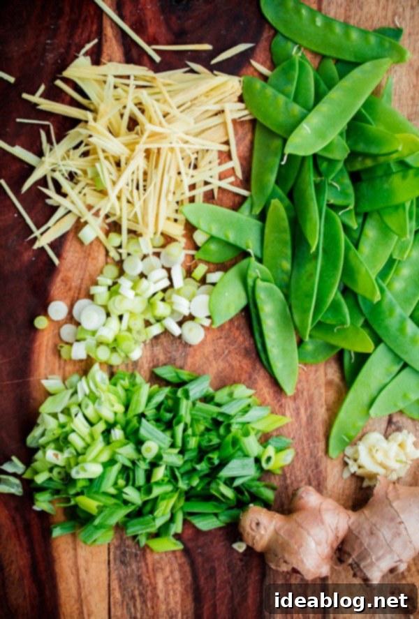 Lightning-Fast Shrimp and Snow Pea Stir Fry 4 Key ingredients for 15-Minute Shrimp and Snow Pea Stir Fry including ginger, garlic, shrimp, and snow peas.