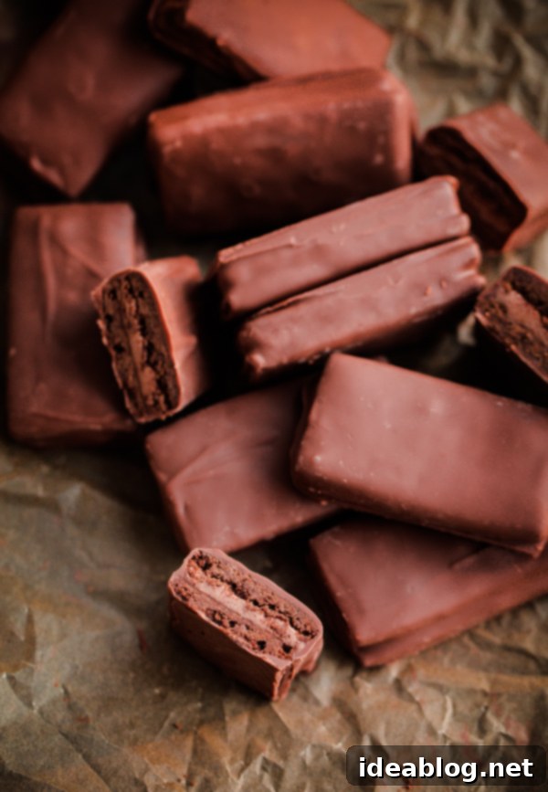 A delicious recipe for homemade Tim Tams - a classic Australian cookie biscuit filled with malted chocolate buttercream and dipped in chocolate. #recipe #chocolate #cookie #timtam #abeautifulplate #dessert Homemade Tim Tams - Australian chocolate biscuit recipe