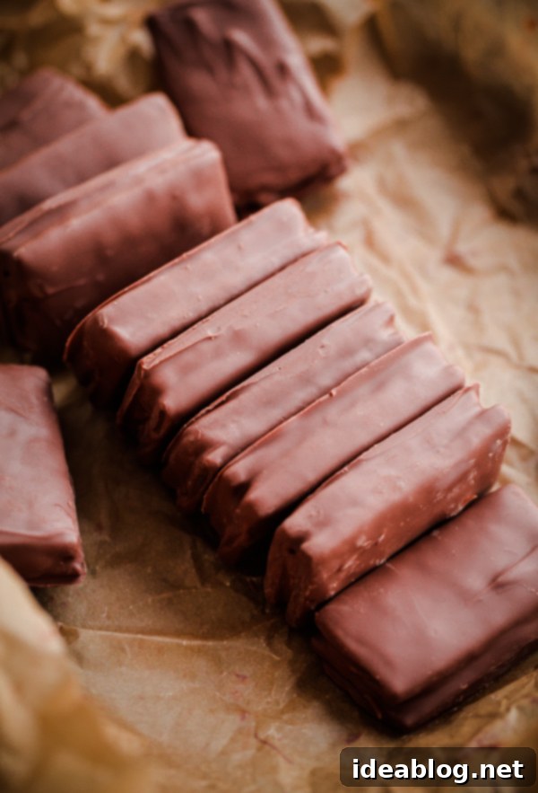A delicious recipe for homemade Tim Tams - a classic Australian cookie biscuit filled with malted chocolate buttercream and dipped in chocolate. #recipe #chocolate #cookie #timtam #abeautifulplate #dessert Homemade Tim Tams: The perfect holiday cookie