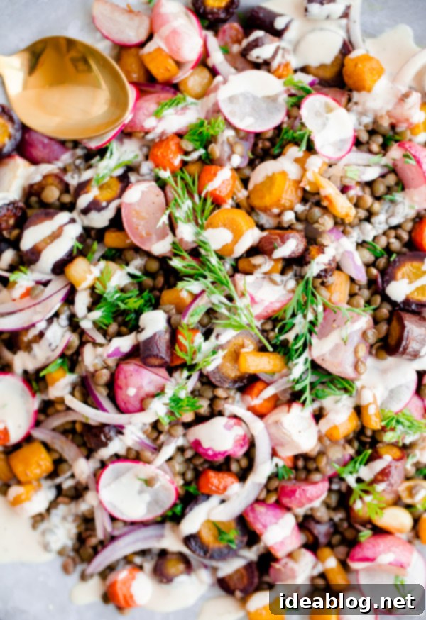 Roasted Carrot Lentil Salad with Radishes and Tahini Dressing: A Wholesome Meal. Artfully presented Roasted Carrot Lentil Salad, showcasing its vibrant ingredients and fresh garnish.
