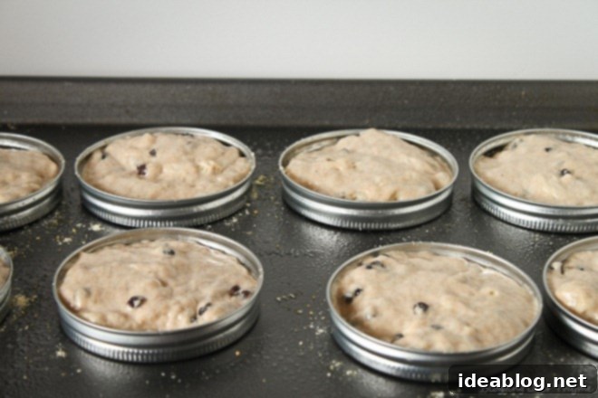 Homemade Cinnamon Raisin English Muffins 4 English muffins baking in the oven using molds