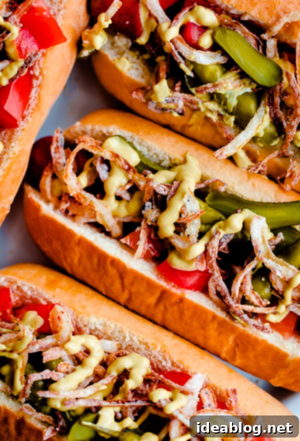 Chicago Hot Dogs Reinvented 2 Gourmet Chicago-Style Hot Dogs topped with celery salt fried onions, Dijon mustard, cornichon, spicy sport peppers, and chopped tomato! Insanely delicious and easy tailgating food.