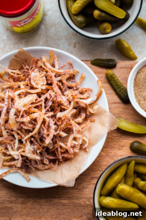 Chicago Hot Dogs Reinvented 4 Fancy Chicago-Style Hot Dogs topped with celery salt fried onions, Dijon mustard, cornichon, spicy sport peppers, and chopped tomato! Insanely delicious and easy tailgating food.