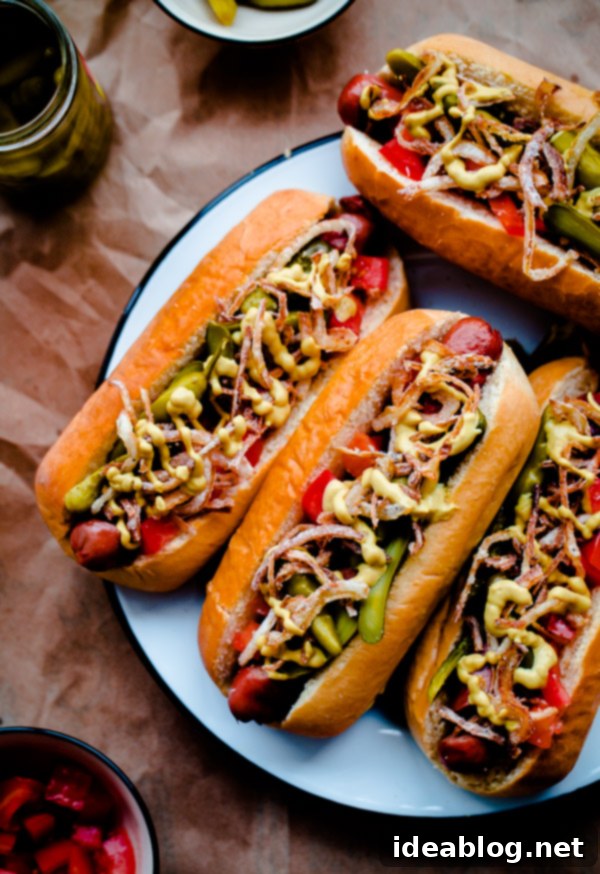 Chicago Hot Dogs Reinvented 8 Fancy Chicago-Style Hot Dogs topped with celery salt fried onions, Dijon mustard, cornichon, spicy sport peppers, and chopped tomato! Insanely delicious and easy tailgating food.