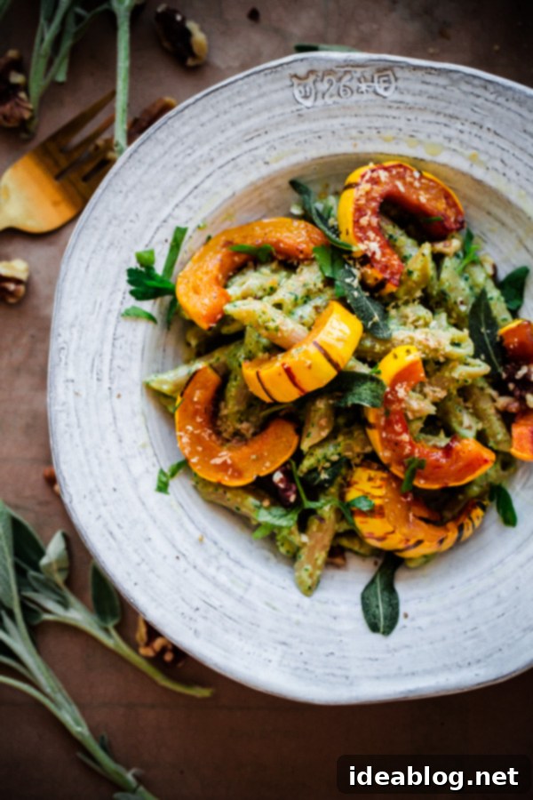 Savory Whole Wheat Pasta with Homemade Walnut-Sage Pesto and Roasted Delicata Squash. A delightful, healthy, and straightforward fall vegetarian pasta!
