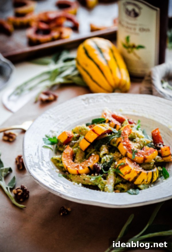 Hearty Whole Wheat Pasta with Flavorful Walnut-Sage Pesto and Golden Roasted Delicata Squash. A delicious, healthy, and easy vegetarian recipe for fall!