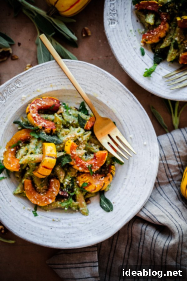 Simple Whole Wheat Pasta with Rich Walnut-Sage Pesto and Delightful Roasted Delicata Squash. A healthy, wholesome, and easy fall vegetarian pasta!