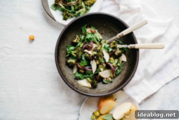 12 Soul-Satisfying Autumn Salads 10 Charred Broccoli and Red Onions with Shaved Apples and Arugula - a unique and flavorful fall salad combination.